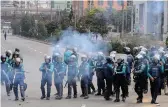  ?? — AP ?? Security personnel use teargas to disperse former Prime Minister Khaleda Zia’s supporters protesting against the court verdict in Dhaka on Thursday.