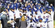  ?? MATT MARTON/ AP ?? Chicago Cubs team members celebrate during the 2016World Series Championsh­ip ring ceremony last week before the team’s game against the Los Angeles Dodgers.