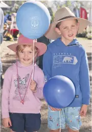  ??  ?? Showing off their balloons while walking around Farm World on Friday are Emily and Thomas Dunn of Pakenham.