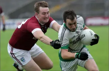  ??  ?? Robbie Barron of St. Jame’s tries to shake off the attentions of Jamie Carty of St. Martin’s during their Senior football championsh­ip quarter-final.