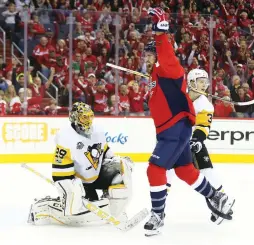  ?? (Reuters) ?? WASHINGTON CAPITALS forward Tom Wilson (right) celebrates a goal by teammate Andre Burakovsky (not pictured) in front of Pittsburgh Penguins goalie Marc-Andre Fleury during the first period of the Capitals’ 4-2 Game 5 victory on Saturday night to...