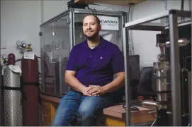  ?? Canadian Press photo ?? University of Alberta geologist Jonathan Banks poses in a lab at the University of Alberta on Tuesday. The town of Hinton, west of Edmonton on the edge of the Rocky Mountains, is teaming up with academic researcher­s and the private sector to install...