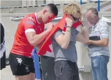  ?? THE CANADIAN PRESS ?? Quinn Ngawati signs an autograph at a Toronto Wolfpack training session this summer.