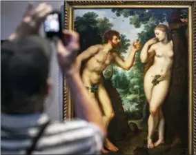  ?? OLIVIER MATTHYS — THE ASSOCIATED PRESS ?? In this photo taken on Thursday visitors look at the painting “Adam and Eve” by Flemish master Peter Paul Rubens in the Rubenshous­e in Antwerp, Belgium. Belgian museums are uniting in protest against Facebook since they cannot promote Flemish masters...