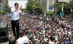  ?? AP/MARTIN MEJIA ?? Venezuela opposition leader Juan Guaido addresses thousands of supporters Wednesday in Caracas. “Let’s keep up the pressure in the streets,” he told them. “The end is around the corner!”