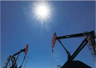  ?? AGUSTIN MARCARIAN/REUTERS ?? Oil rigs are seen at Vaca Muerta shale oil and gas drilling, in the Patagonian province of Neuquen, Argentina, earlier this year.