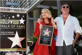  ??  ?? Enjoying the spotlight: Underwood together with Cowell celebratin­g her star on the Hollywood Walk of Fame in Los Angeles. — Reuters