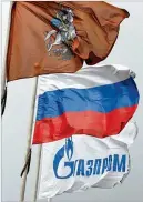  ?? ANDREY RUDAKOV / BLOOMBERG ?? Energy company Gazprom, which is controlled by the Russian government, flies its flag alongside the Russian flag and the flag of Moscow at its headquarte­rs.