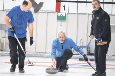  ??  ?? Shelburne skip Greg Hicks is flanked by team mates Peter Deschamp (left) and Dave Foged while delivering a rock during semi-final action at the annual Lobster Spiel at the Barrington Regional Curling Club.