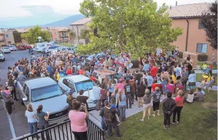  ??  ?? A couple hundred friends, neighbors and other community members gathered at the Northwest Albuquerqu­e apartment complex where Victoria Martens was killed to pray and grieve.