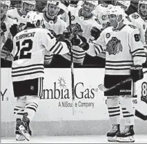  ?? KIRK IRWIN/GETTY ?? Alex DeBrincat is congratula­ted by Patrick Kane after DeBrincat’s goal in the first period. Kane scored two of his own in the third period.