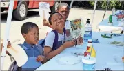  ?? Spencer Lahr / Rome News-Tribune ?? Deshaun Adams (from left), 4; J’Marrcus Sullivan Jr., 10; and Anthony Whatley, 11, sit at a table after finishing their meal.