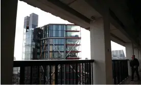  ?? Photograph: Hannah McKay/Reuters ?? Visitors look out from the viewing level towards a luxury block of flats from the Tate Modern gallery in London.