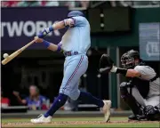  ?? LM OTERO — THE ASSOCIATED PRESS ?? Texas Rangers’ Josh Jung, left, hits a home run in front of Colorado Rockies catcher Austin Wynns during the second inning of a baseball game in Arlington, Texas, Sunday.