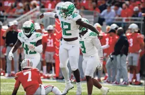  ?? Jay LaPrete / Associated Press ?? Oregon defensive end DJ Johnson, front, celebrates his sack of Ohio State quarterbac­k C.J. Stroud on the final play of the game on Saturday in Columbus, Ohio.