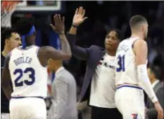  ?? ASSOCIATED PRESS FILE ?? No, Markelle Fultz, center, is not waving goodbye. He’s about to high five Jimmy Butler in a game against Oklahoma City earlier this season. The 76ers traded the oft-injured former overall No. 1 pick to Orlando Thursday.