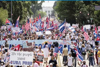  ?? DREW ANGERER Getty Images ?? Activists and supporters of protesters against the Cuban regime march from the White House to the Cuban Embassy on 16th Street during a rally on Monday in Washington, D.C.