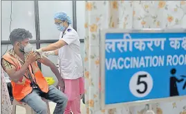  ??  ?? A frontline worker gets the vaccine shot at Shatabdi Hospital on Friday.