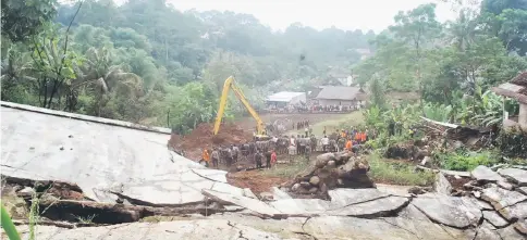  ??  ?? A damaged section of the Bogor-Sukabumi railway is seen as rescue workers, including members of the police and military, search for victims of a landslide following heavy rains in Warung Menteng Village, Bogor Regency, West Java in this photo taken by...