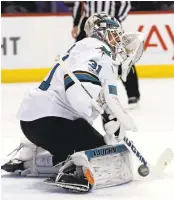  ?? DAVID ZALUBOWSKI/ASSOCIATED PRESS ?? Sharks goalie Martin Jones makes a stick save of a shot against the Avalanche in the first period on Monday.