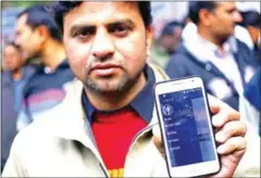  ?? ANINDITO MUKHERJEE/REUTERS/THE STRAITS TIMES ?? An Uber taxi driver shows the app on his Samsung mobile during a protest against a ban on online taxi services in New Delhi, India on December 12, 2014.
