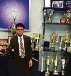  ?? K.R. Nayar/Gulf News ?? Anis Sajan, the owner of Danube cricket team, with the cricket trophies that his teams have won over the years.