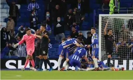  ??  ?? Brighton’s players celebrate Dan Burn’s winner while Manchester City’s players appeal for offside. Photograph: Gareth Fuller/Reuters