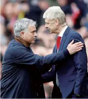  ??  ?? Arsene Wenger of Arsenal (right) and Jose Mourinho of Manchester United greet each other on Sunday. — Reuters