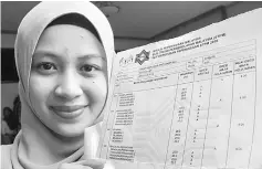  ??  ?? Najla shows off her STPM results.