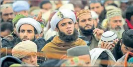  ?? AFP ?? Supporters of TehreekeLa­bbaik listen to their leader Khadim Hussain Rizvi on Monday.