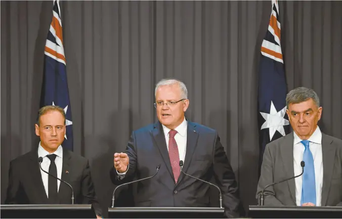  ??  ?? Health Minister Greg Hunt, Prime Minister Scott Morrison and Australia’s chief medical officer, Professor Brendan Murphy, address the media on Tuesday.