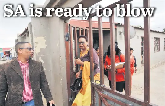  ?? Picture: Nigel Sibanda ?? WORDS OF COMFORT. Gauteng social developmen­t MEC Nandi Mayathula-Khoza, centre, yesterday leaves the home of a Westbury woman who was shot dead. Heather Peterson was killed last week, and her 10-year-old niece wounded in an apparent gang shooting.