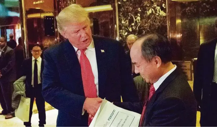  ?? Rex Features ?? US President-elect Donald Trump and Masayoshi Son, CEO and founder of SoftBank, at the Trump Tower in New York last month. While Son will have the ultimate say, a small group of Deutsche Bank refugees — led by Rajeev Misra, one of Anshu Jain’s most...