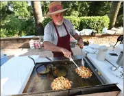  ?? ?? Jim Mayoral with Funnel Cake Express fries up the popular dessert Thursday during Fiesta Days at Andrews Park in Vacaville.