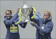  ?? AP PHOTO ?? Edna Kiplagat, left, and Geoffrey Kirui, both of Kenya, hold a trophy together after their victories in the 121st Boston Marathon on Monday.