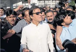  ?? B.K. BANGASH/THE ASSOCIATED PRESS ?? Imran Khan leaves Pakistan's lower house of parliament. With rare support from the opposition, parliament has passed a bill to give equal rights to 5 million.