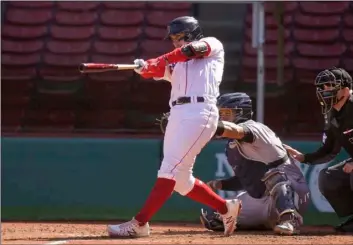  ?? AP Photo/Steven Senne ?? Boston Red Sox’s Michael Chavis (left) hits a three-run home run as New York Yankees’ Gary Sanchez, behind center, looks on in the third inning of a baseball game, on Sunday in Boston.