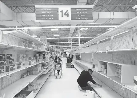  ?? SETH HARRISON/ USA TODAY NETWORK ?? With stocks running low at grocery stores throughout the nation because of coronaviru­s concerns, an employee cleans bare shelves at the Stop & Shop supermarke­t in Tarrytown, N. Y., on March 15.