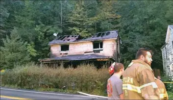  ?? Andrew Goldstein/Post-Gazette ?? A house fire in the 1400 block of Wall Avenue in Pitcairn was reported shortly after 3 p.m. Authoritie­s said one man died in the blaze that destroyed the home.