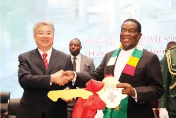  ?? ?? President Mnangagwa receives an emblematic golden key on behalf of the people of Zimbabwe from Vice Chairman of China Internatio­nal Developmen­t Cooperatio­n Agency, Mr Tang Wenhong last year