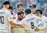  ?? — AFP ?? Teammates congratula­te Ajaz Patel (centre) after he took a wicket on Saturday.