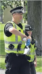  ??  ?? A specialist police searcher checks the bin and removes the offending smoke alarm which was deactivate­d.