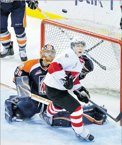  ?? — PNG MERLIN ARCHIVE ?? Vancouver Giants Riley Kieser (right) and goalie Cole Cheveldave of the Kamloops Blazers watch the puck soar in third period action on Feb. 3 at the Pacific Coliseum.