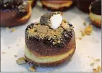  ?? DANA JENSEN/THE DAY ?? The S’mores doughnut is filled with marshmallo­w, dipped in chocolate and sprinkled with graham cracker. A toasted marshmallo­w is placed on top.