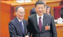  ?? REUTERS ?? Chinese President Xi Jinping (right) shakes hands with newly elected Chinese Vice President Wang Qishan at the plenary session of the National People's Congress.