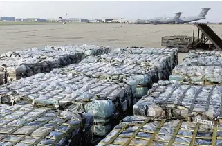  ?? /Tina M Ackerman/US Navy/Getty Images ?? Effort and sacrifice: Piles of UN rations are dropped off in Afghanista­n in an effort to provide relief to refugees. Author Greg Mills visited the country extensivel­y over several years and served as an adviser to Nato.