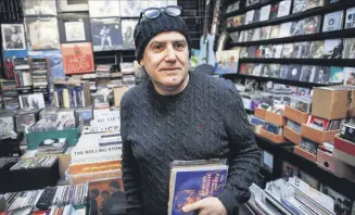  ??  ?? Süleyman Özyıldırım holds David Bowie’s “Space Oddity” record at his shop, Shades in Ankara’s Çankaya district that sells cassettes, CDs and vinyl LPs, many of which are relatively hard to find, on Feb. 2, 2019.