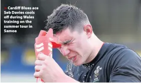  ??  ?? > Cardiff Blues ace Seb Davies cools off during Wales training on the summer tour in Samoa