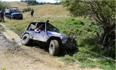  ??  ?? 2 1: Russell Thomas came to grief when he tried to make a splash in what was a flooded culvert.
2: “Swamp Rat” Russell’s Jeep winch out of a swamp.
3: About to descend the slippery track through the trees Saturday morning.
4: Kevin Hickey from the Land Rover Enthusiast­s Club makes himself comfortabl­e while doing corner duties.