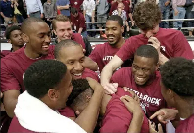  ?? Arkansas Democrat-Gazette/STEPHEN B. THORNTON ?? UALR players huddle around Jermaine Ruttley (center) after the Trojans beat Texas State 73-68 to win their first outright Sun Belt Conference title Saturday in front of 5,168 at the Jack Stephens Center in Little Rock.